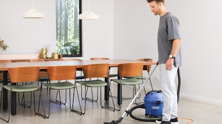 guy vacuuming with glide wispa 300 canister vacuum