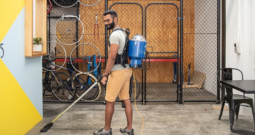 guy wearing superpro 700 backpack vacuum
