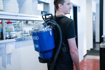 guy wearing duo backpack vacuum cleaner